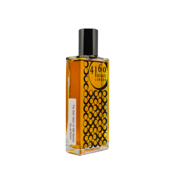 A rectangular glass bottle of 4160Tuesdays' Dark Heart of Old Havana Eau de Parfum with a black cap and circular pattern design on the front. The liquid inside is a golden yellow color, reminiscent of sunny afternoons in Old Havana.