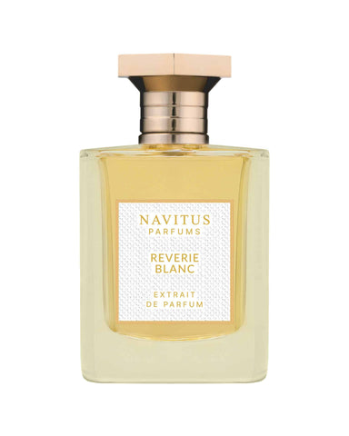 Perfume bottle with gold cap, amber glass; label reads Reverie Blanc