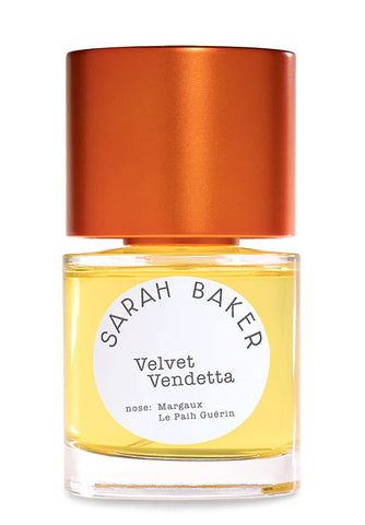 Perfume bottle with amber-gold liquid and orange cap; Sarah Baker Velvet Vendetta