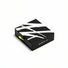 A black and white box with "AKRO 3 x 2ml Discovery Kit" printed on the side, a green pull tab sticking out, and a hint of fragrances inside by Akro.
