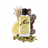 A bottle of Akro's AWAKE Eau de Parfum is showcased alongside coffee beans, lemon slices, cardamom pods, and roots in the background, emphasizing its distinctive coffee fragrance. This unisex perfume is ideal for those who desire a bold and refreshing scent.