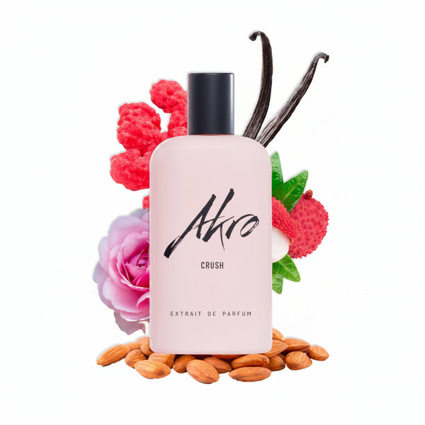 Pink Airo extrait de parfum perfume bottle with black cap, near flowers and vanilla beans