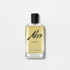 A bottle of Akro AWAKE Eau de Parfum with a black cap and clear glass container filled with light yellow liquid. The label features black cursive text, capturing the essence of a coffee fragrance in this unisex perfume.