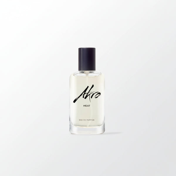 Eau de parfum bottle with black cap, clear glass, Ahro Heat label on front