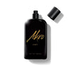 A black perfume bottle labeled "East" by Akro evokes the essence of Oud from the Middle East, with "Eau de Parfum" inscribed at the bottom. The cap is off and placed to the right.