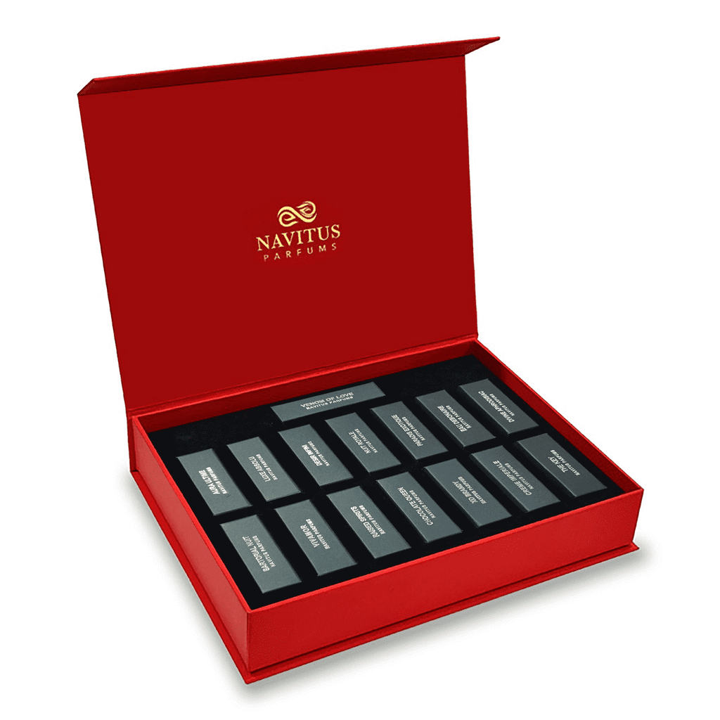 A red box with the Navitus Parfums logo on the lid contains twelve labeled perfume samples, elegantly presented as part of their Navitus Allure Discovery Set.