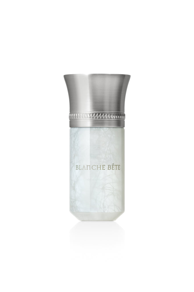 A bottle of Blanche Bête perfume from Liquides Imaginaires, featuring a metallic cap and a pristine white body, exudes an enchanting scent as if crafted by a mythical creature.