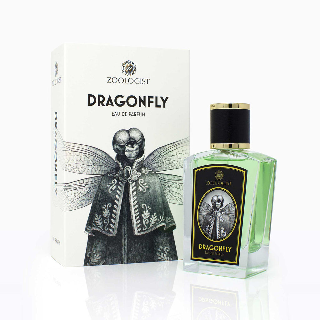 A green perfume bottle labeled "Dragonfly 2021" with a matching box featuring an illustration of a dragonfly-headed figure in a suit and the brand name "Zoologist," evokes the essence of an Impressionistic Pond with its new perfume, blending aquatic florals seamlessly.