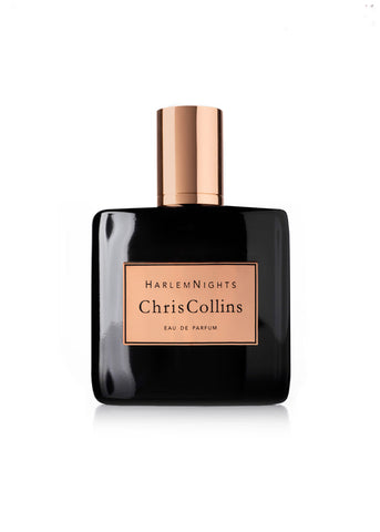 A bottle of Harlem Nights by Chris Collins Eau de Parfum, featuring a sleek black design with an elegant gold cap and label, is showcased against a white background, emanating an aura of evening scent seduction.