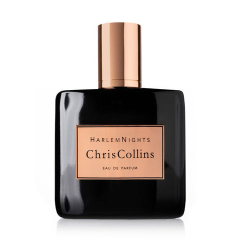 A bottle of Harlem Nights by Chris Collins Eau de Parfum, featuring a sleek black design with an elegant gold cap and label, is showcased against a white background, emanating an aura of evening scent seduction.