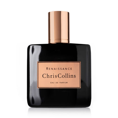 Dark eau de parfum bottle with rose-gold cap, rectangular label reading Renaissance