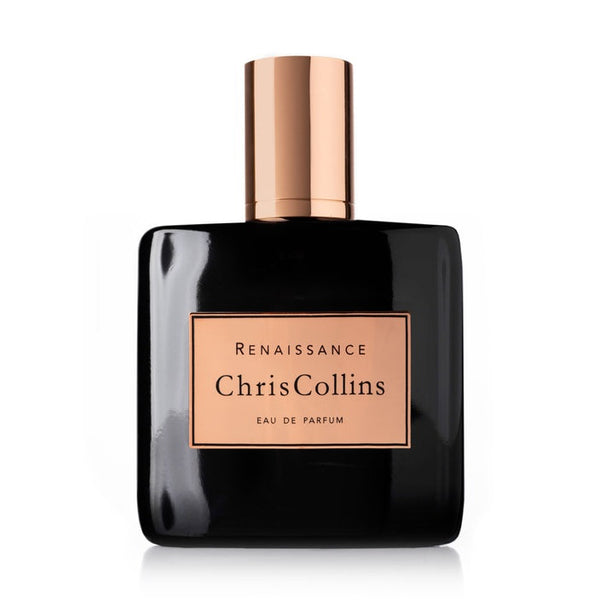 Dark eau de parfum bottle with rose-gold cap, rectangular label reading Renaissance