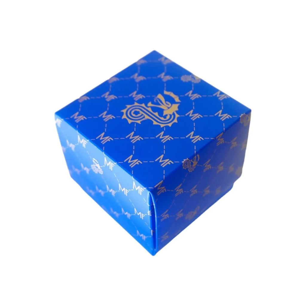 A blue, cube-shaped box featuring a repeating pattern of interconnected lines and an emblem of a dragon on one side, perfect for holding your Basilica Candle by Milano Fragranze.