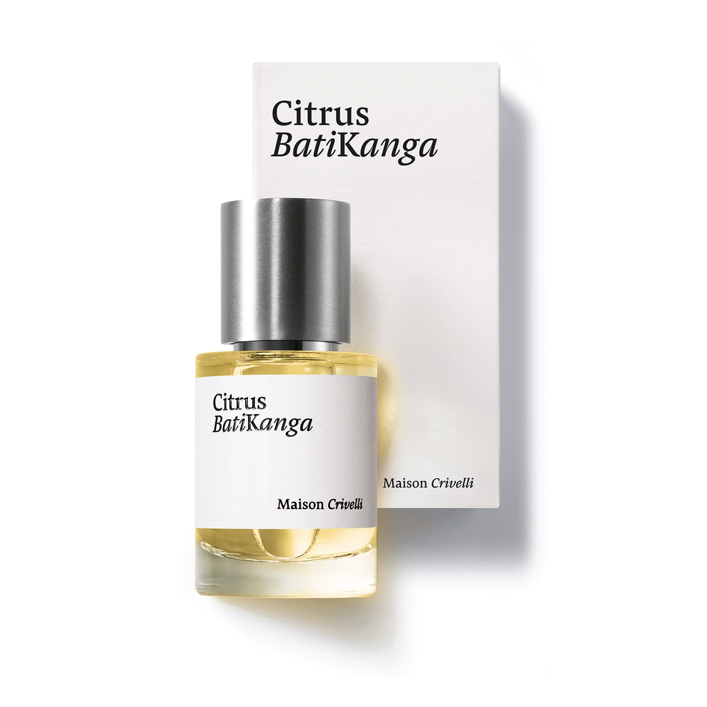 Next to its branded white box, a bottle of Citrus Batikanga by Maison Crivelli is displayed. The bottle, capped with silver, contains a blend infused with bergamot essential oil that evokes a citrusy, spicy, and woody aroma.