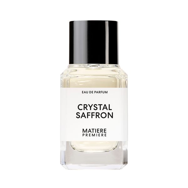 A clear glass perfume bottle with a black cap, labeled "CRYSTAL SAFFRON" by Matiere Premiere, featuring notes of Ambroxan.