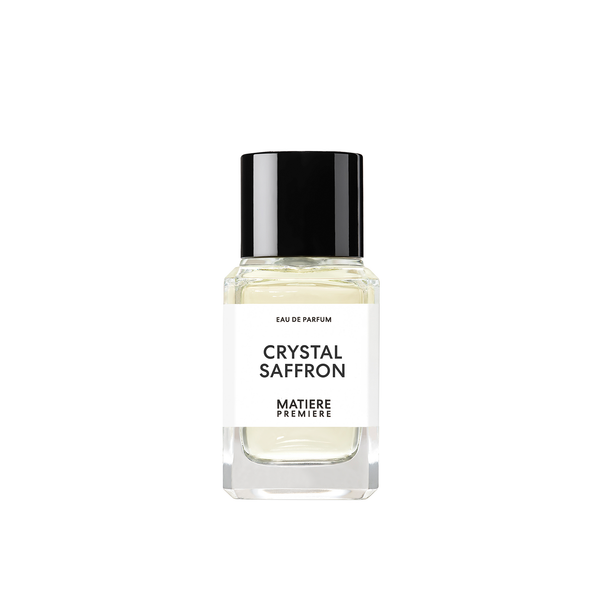 A clear glass bottle of Eau de Parfum labeled "CRYSTAL SAFFRON" by Matiere Premiere, featuring a black cap and white label, infused with the rich essence of Saffron Oil.