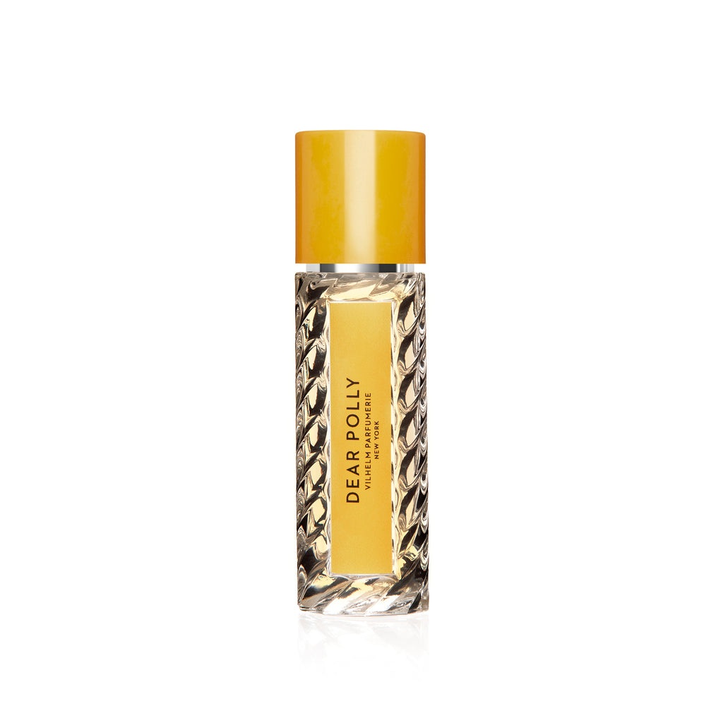 A Vilhelm Parfumerie glass perfume bottle labeled "Dear Polly" with a yellow cap and textured sides, evoking the warm notes of bergamot and Ceylon black tea.