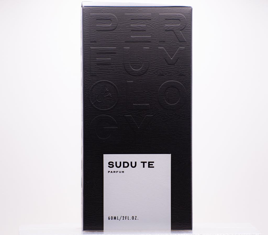 A black and white rectangular perfume box labeled "Perfumology Sudu Te" with a capacity of 60 mL or 2 fl. oz. The box, inspired by Sri Lanka, features an embossed design on the surface hinting at its subtle white tea essence.
