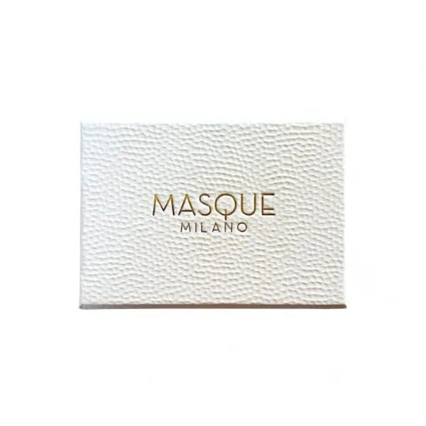 A box with a textured white surface bearing the gold-embossed text "Masque LE DONNE DI MASQUE DISCOVERY KIT 6 X 2ML" from Masque Milano contains an array of exquisite fragrances.