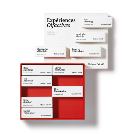 Two open Maison Crivelli perfumes sets reveal their treasures; a red box with ten perfume samples and a white box with six, each showcasing their unique fragrances and olfactory signature.