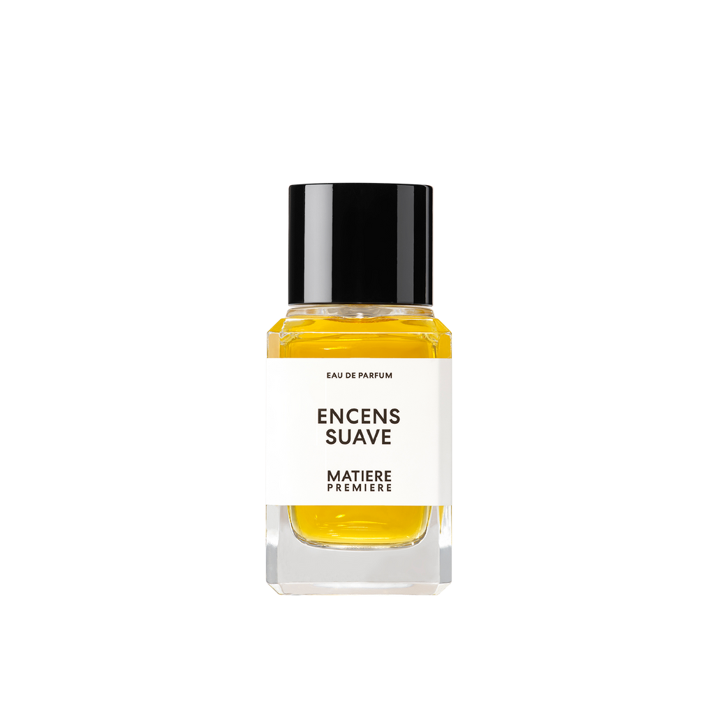 The "ENCENS SUAVE" Eau de Parfum by Matiere Premiere comes in a bottle with a black cap and features yellow liquid inside. It has a white label on the front, and the fragrance is enriched with notes of Resin Incense that add depth to its aromatic profile.