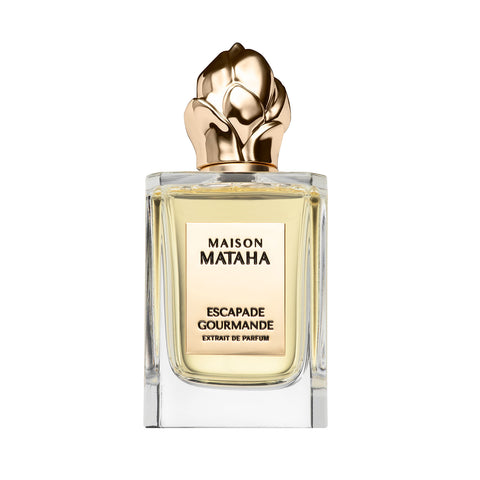 Perfume bottle with ornate gold cap and clear glass; centered front label