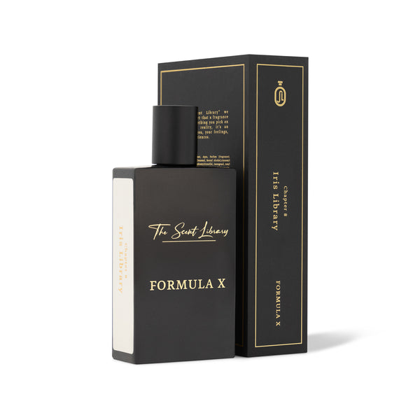 A black bottle of perfume labeled "Formula X" from The Scent Library is positioned next to its matching black and gold box, which also reads "Formula X" and "The Scent Library" on the side. The elegant Iris fragrance within whispers of an alchemist's secret, making it truly captivating.