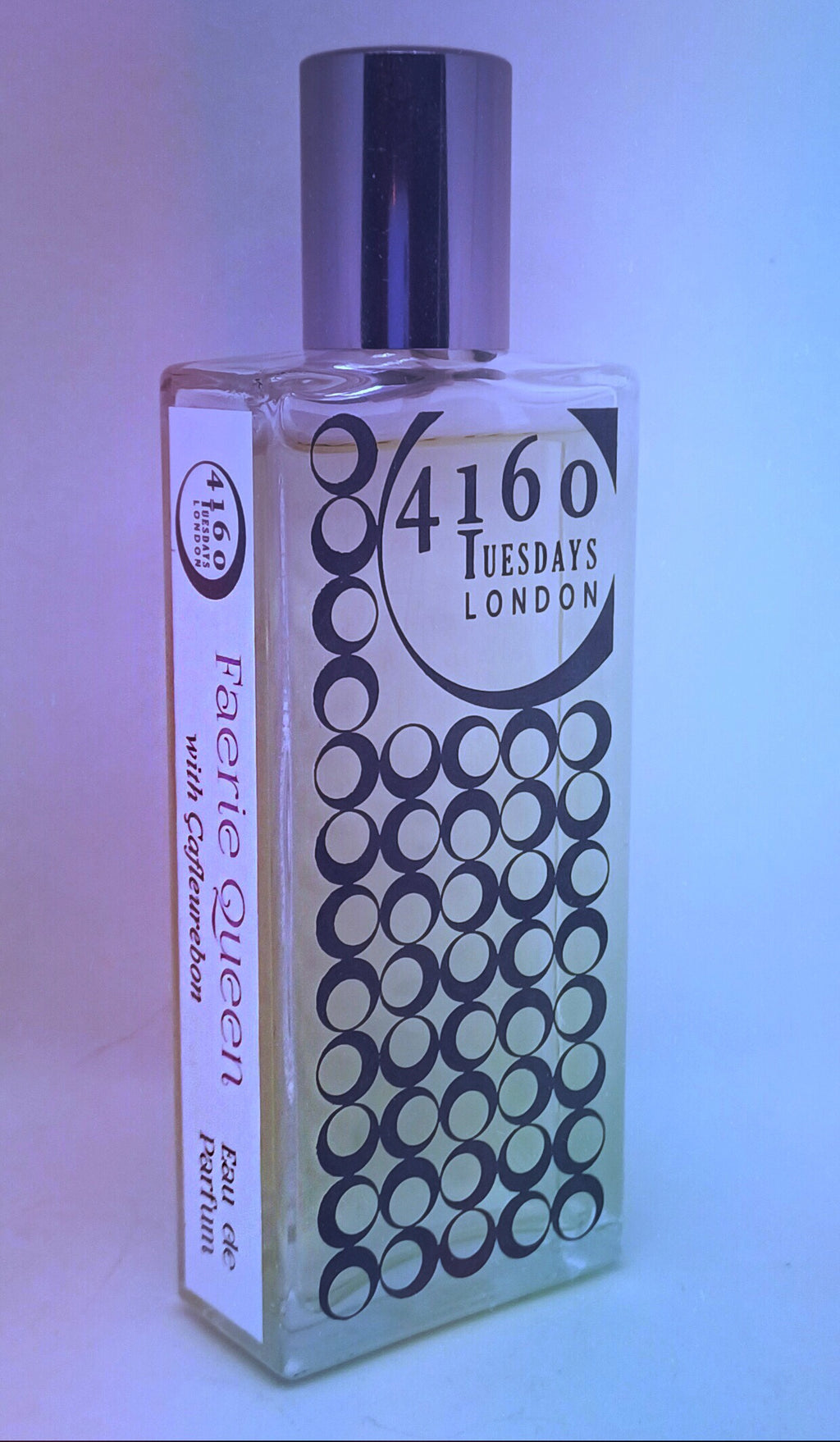 A bottle labeled "4160Tuesdays" with "Faerie Queen" written on the side. The bottle, exuding a hint of vanilla and kumquat, has a cylindrical cap and a patterned front.