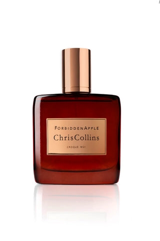 Amber glass perfume bottle with rose-gold cap, label reading Chris Collins Croque Moi