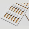 The Gallivant Nomad Set 2024 by Gallivant Perfumes features a neatly arranged collection of 12 small vials of EAU DE PARFUM, each labeled with different names, displayed in an open white box.