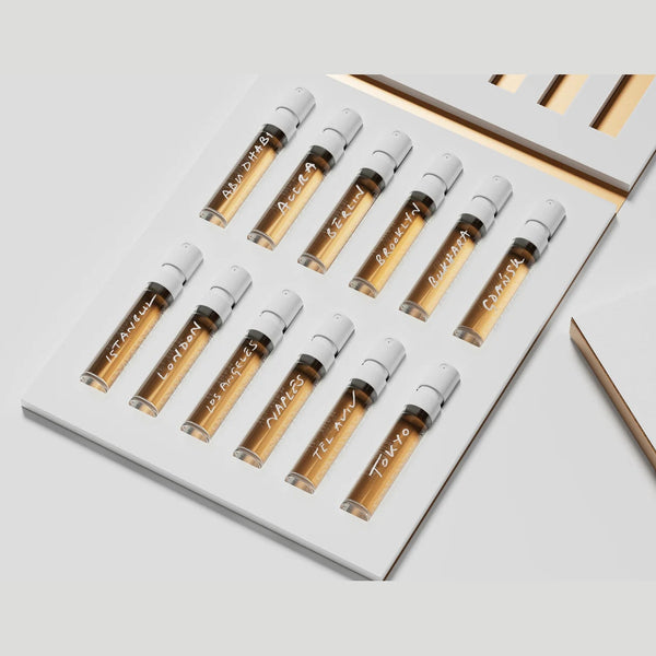 The Gallivant Nomad Set 2024 by Gallivant Perfumes features a neatly arranged collection of 12 small vials of EAU DE PARFUM, each labeled with different names, displayed in an open white box.
