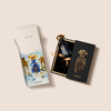 A blue perfume bottle with a gold cap is displayed partially out of its black and gold box, promising an olfactory journey. Another colorful box with an image of the Granada Sapphire Collection by Widian stands nearby, hinting at the luxury scent within.