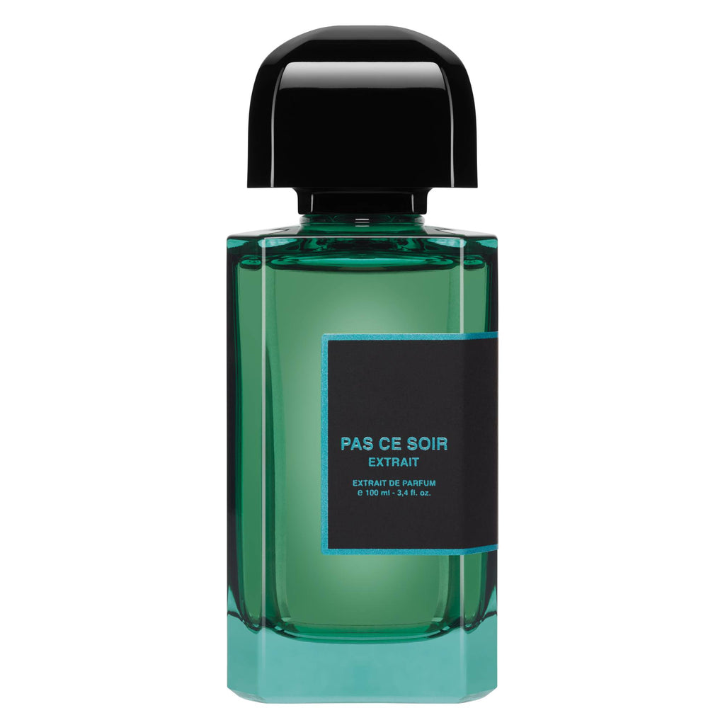 A 100 ml (3.4 fl. oz.) bottle of BDK Parfums' 'Pas Ce Soir Extrait' parfum, featuring a black cap and turquoise liquid, exudes a captivating fruity and floral aroma.