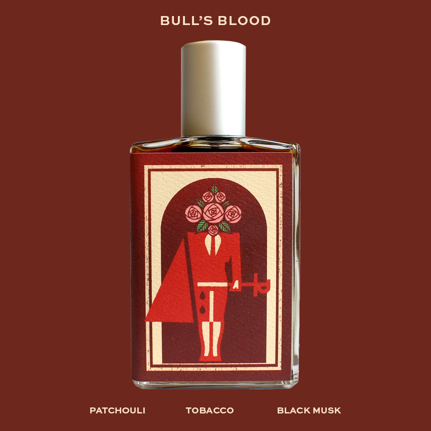 The rectangular perfume bottle from Imaginary Authors is labeled "Bull's Blood" and showcases an illustration of a matador with roses for a head. Below the image, the notes "Patchouli, Tobacco, Black Musk" are listed. This timeless fragrance embodies the spirit of both lovers and brawlers.