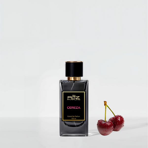 A dark glass bottle labeled "CEREZA" from RDZ Parfums, with a black and gold cap, exudes an aura of luxury fragrance as it stands next to two red cherries on a light background.