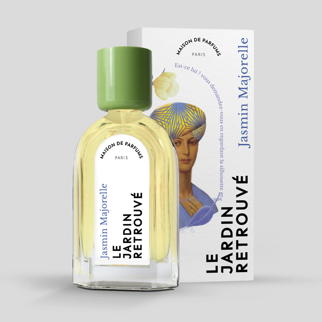 A perfume bottle labeled "Le Jardin Retrouvé - Jasmin Majorelle" stands in front of its matching box, featuring an illustration and text. The Jasmin Majorelle Eau de Parfum bottle from Le Jardin Retrouvé has a green cap.