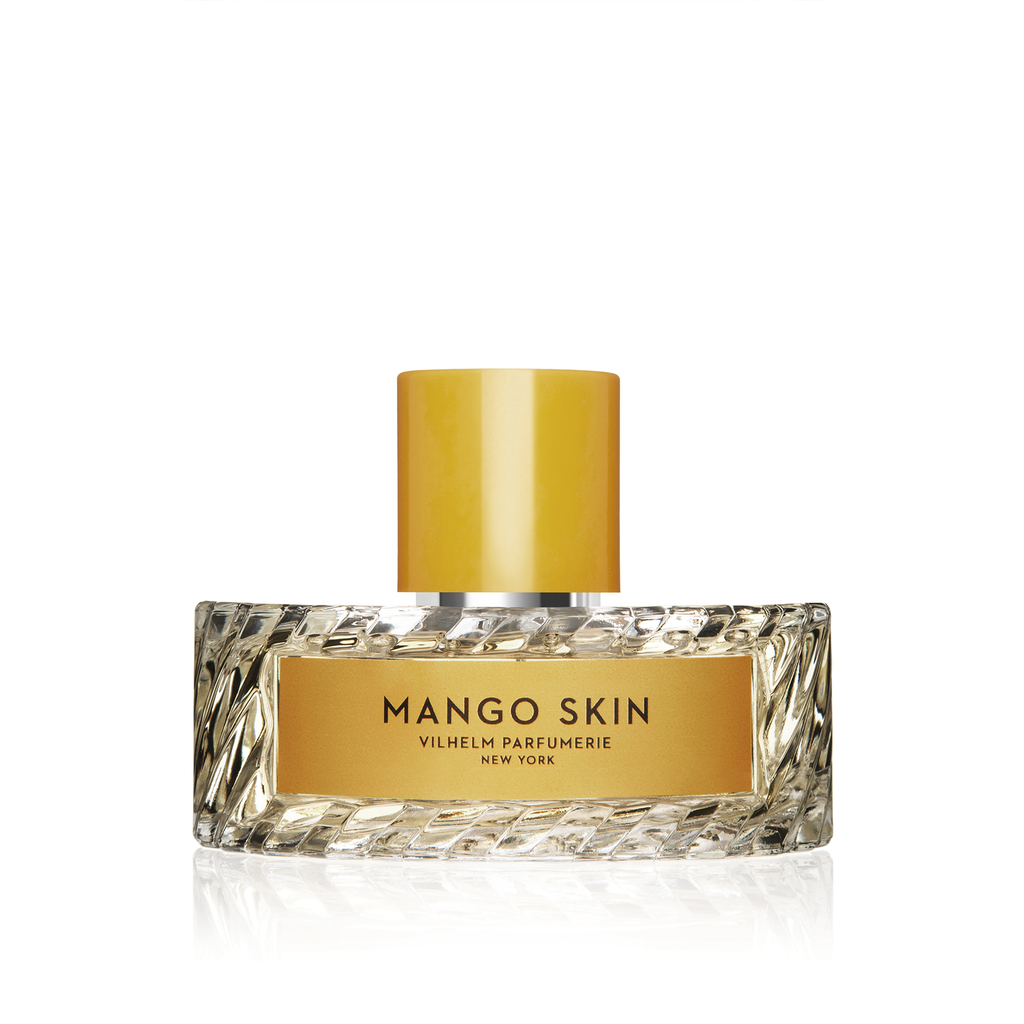A perfume bottle labeled "Mango Skin" by Vilhelm Parfumerie, featuring a yellow cap, a textured glass design, and the sweet essence of mango blended with blackberries.