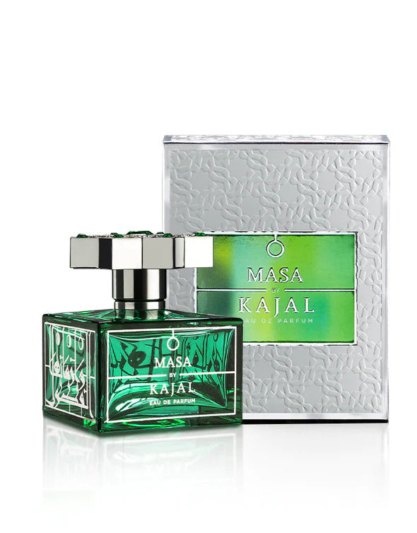 A green bottle of Masa By Kajal from the Kajal - Classic Collection is displayed next to its metallic-textured packaging box. The bottle, resembling the resilience of a diamond, has a silver cap and a green label with white text.
