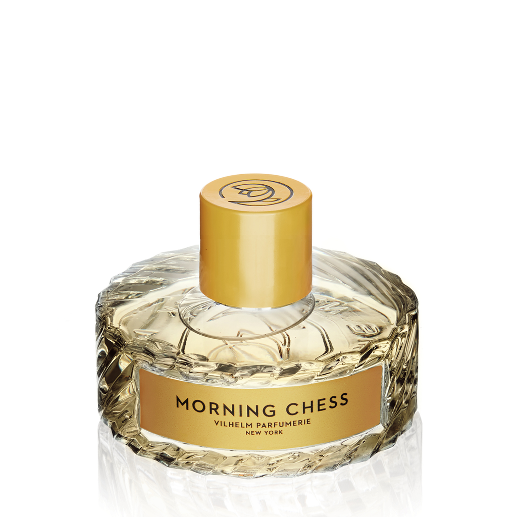 A bottle of Vilhelm Parfumerie's "Morning Chess" perfume, showcasing a textured glass design and a gold cap, incorporates notes of Bergamot.