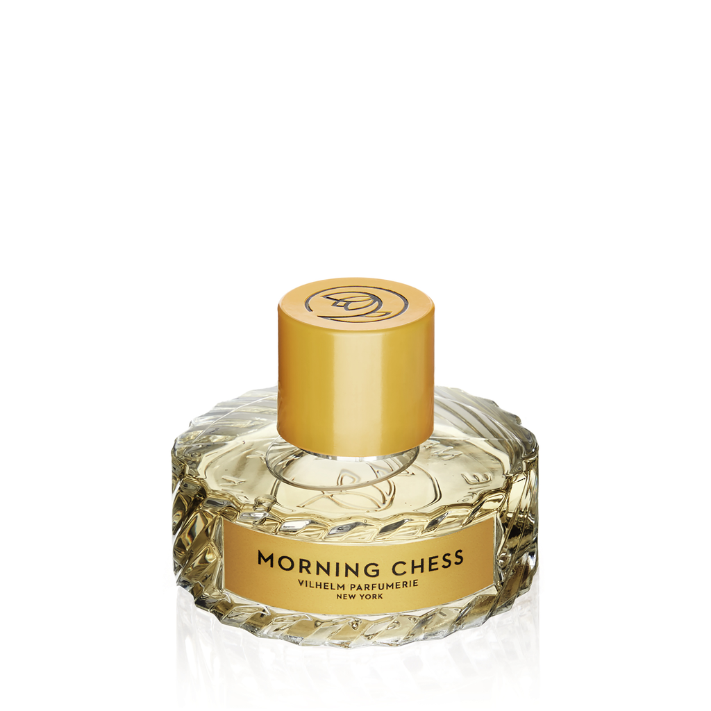 A bottle of Morning Chess perfume by Vilhelm Parfumerie, featuring a gold cap and a clear, faceted glass body with hints of patchouli.