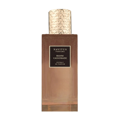 A rectangular perfume bottle with a textured gold cap and a label reading "Mahni Cassonade, Navitus Parfums, Extrait de Parfum." This addictive scent, crafted by Bertrand Duchaufour, promises an olfactory journey like no other.