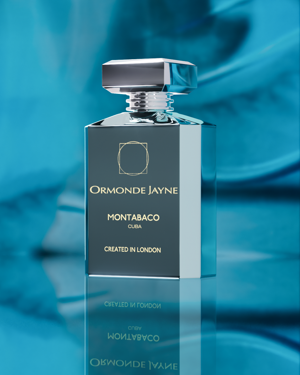 A rectangular bottle of Montabaco Cuba by Ormonde Jayne with a shiny cap, placed against a blue background reflecting on the surface below. Text on bottle reads "Created in London," capturing the rich Latin American flavor and essence of tobacco leaves.