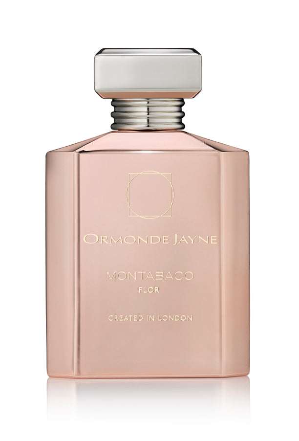 A pink bottle of Ormonde Jayne's Montabaco Flor perfume with a silver cap and a label stating "Created in London," featuring a delightful rose jasmine blend that pairs seamlessly with its sandalwood base.