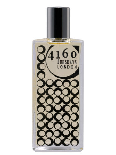 A rectangular perfume bottle with a black cap, labeled "4160Tuesdays," showcases a pattern of black circles on the lower half of the bottle. This exquisite eau de parfum, named "My Eau My!," exudes elegance and sophistication.