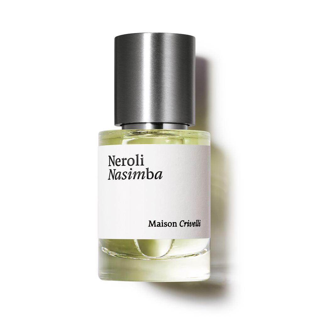 A clear glass bottle of "Neroli Nasimba" perfume by Maison Crivelli, featuring a metallic cap and containing a yellowish liquid. This exquisite floral leather eau de parfum is enriched with orange blossom absolute.