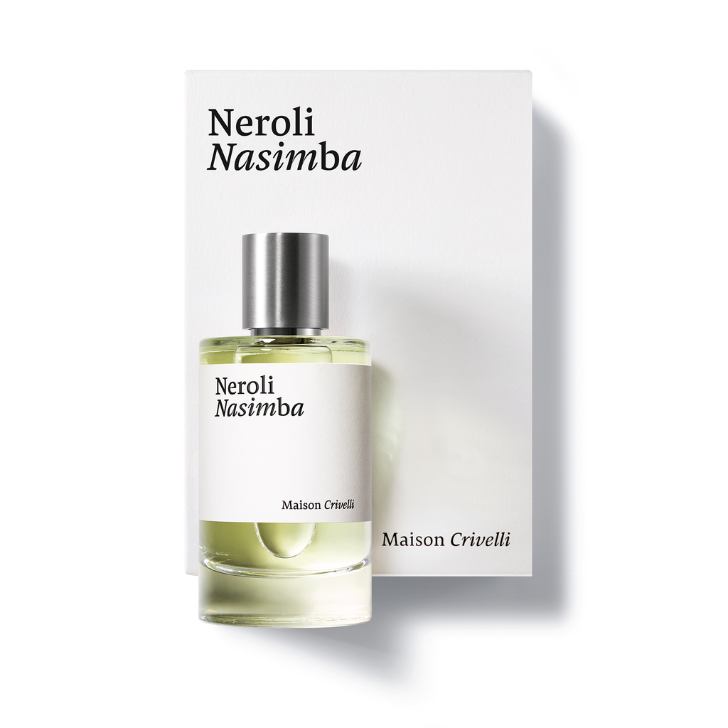 A bottle of Neroli Nasimba by Maison Crivelli, enriched with orange blossom absolute, is positioned in front of its matching box, both featuring a minimalist black and white design.