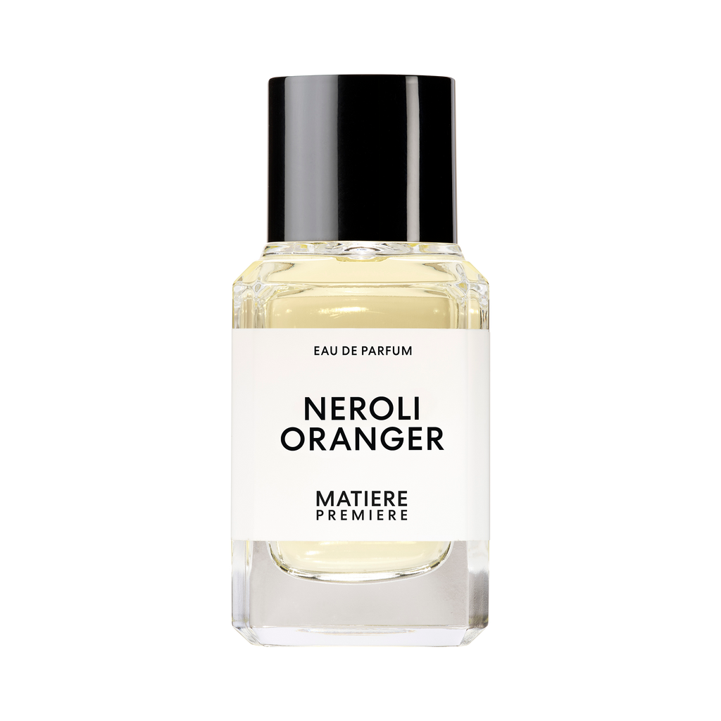 A clear glass bottle with a black cap containing a perfume labeled "NEROLI ORANGER" by Matiere Premiere, enriched with the delicate essence of Orange Blossom.