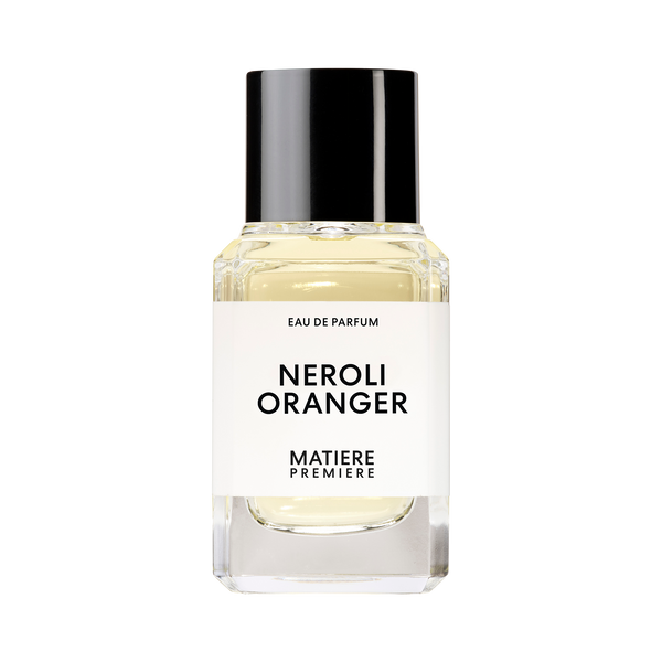 A clear glass bottle with a black cap containing a perfume labeled "NEROLI ORANGER" by Matiere Premiere, enriched with the delicate essence of Orange Blossom.