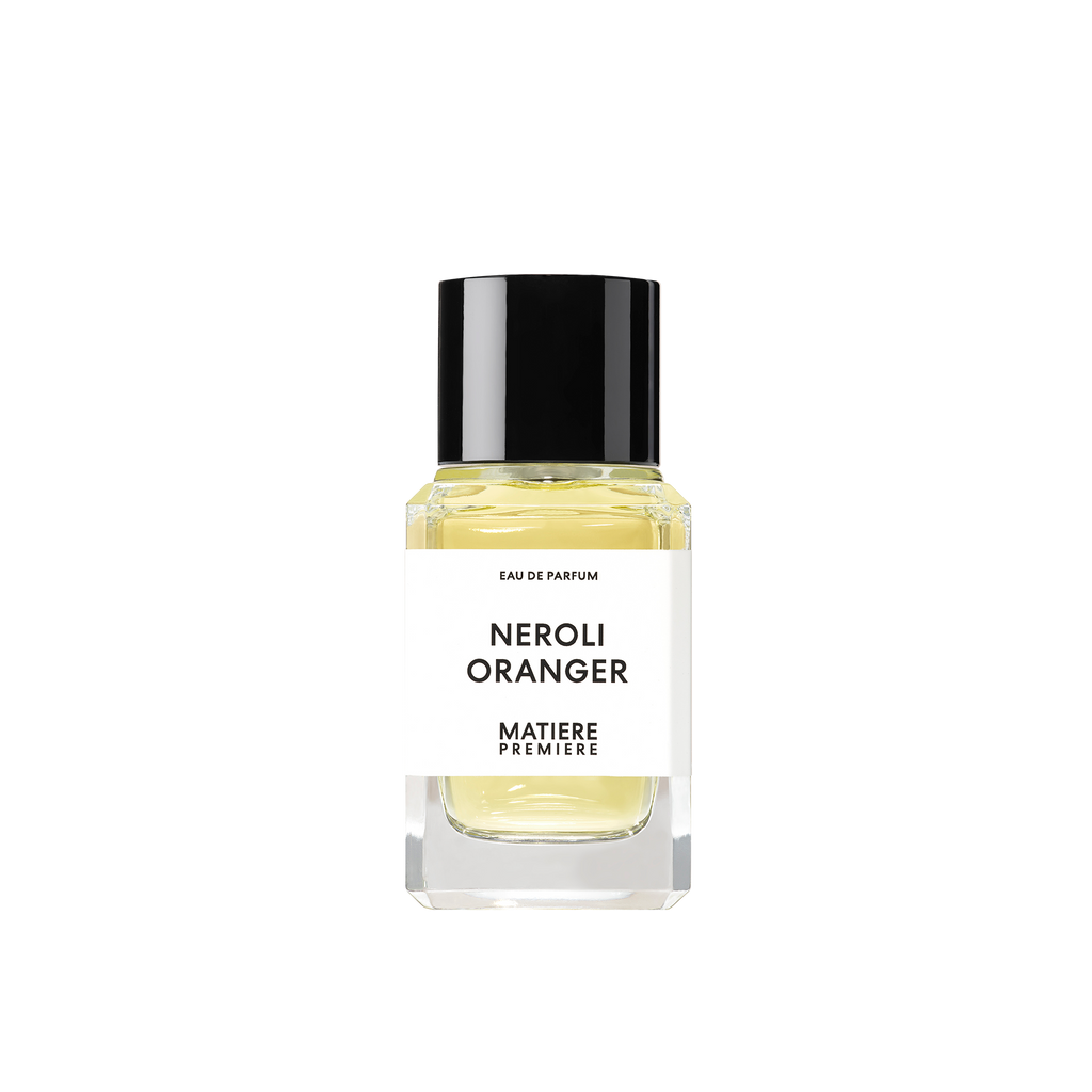 A bottle of NEROLI ORANGER by Matiere Premiere, infused with Orange Blossom, features a black cap and a white label displaying the product name. The light yellow fragrance liquid inside exudes elegance.