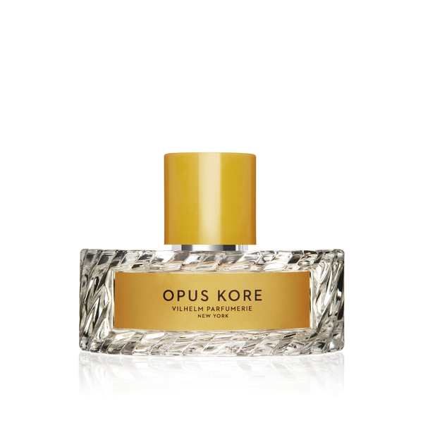 A glass bottle of Opus Kore by Vilhelm Parfumerie, New York, with a gold cylindrical cap, captures the essence of Sicilian lemon.